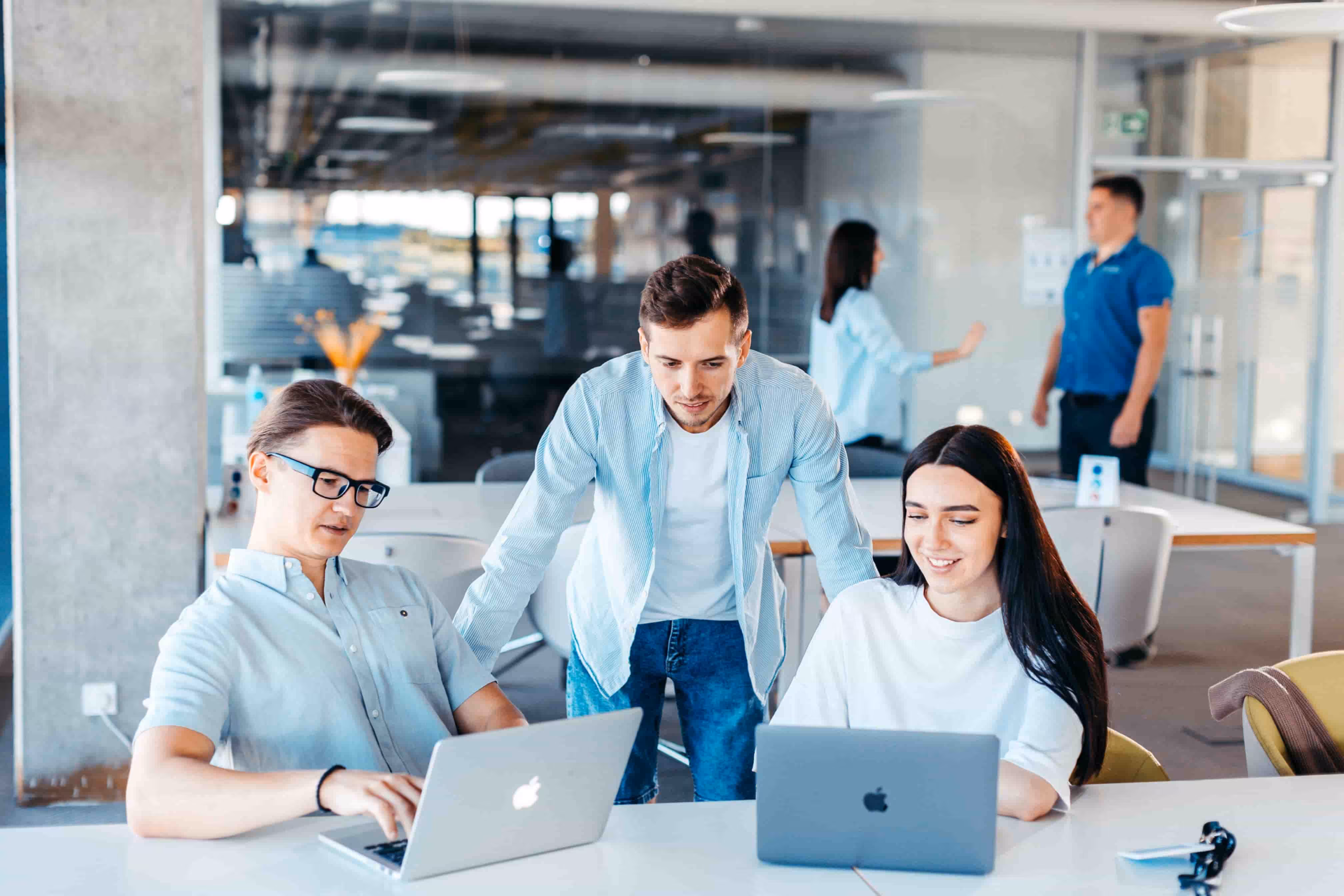 three coworkers collaborating around a table