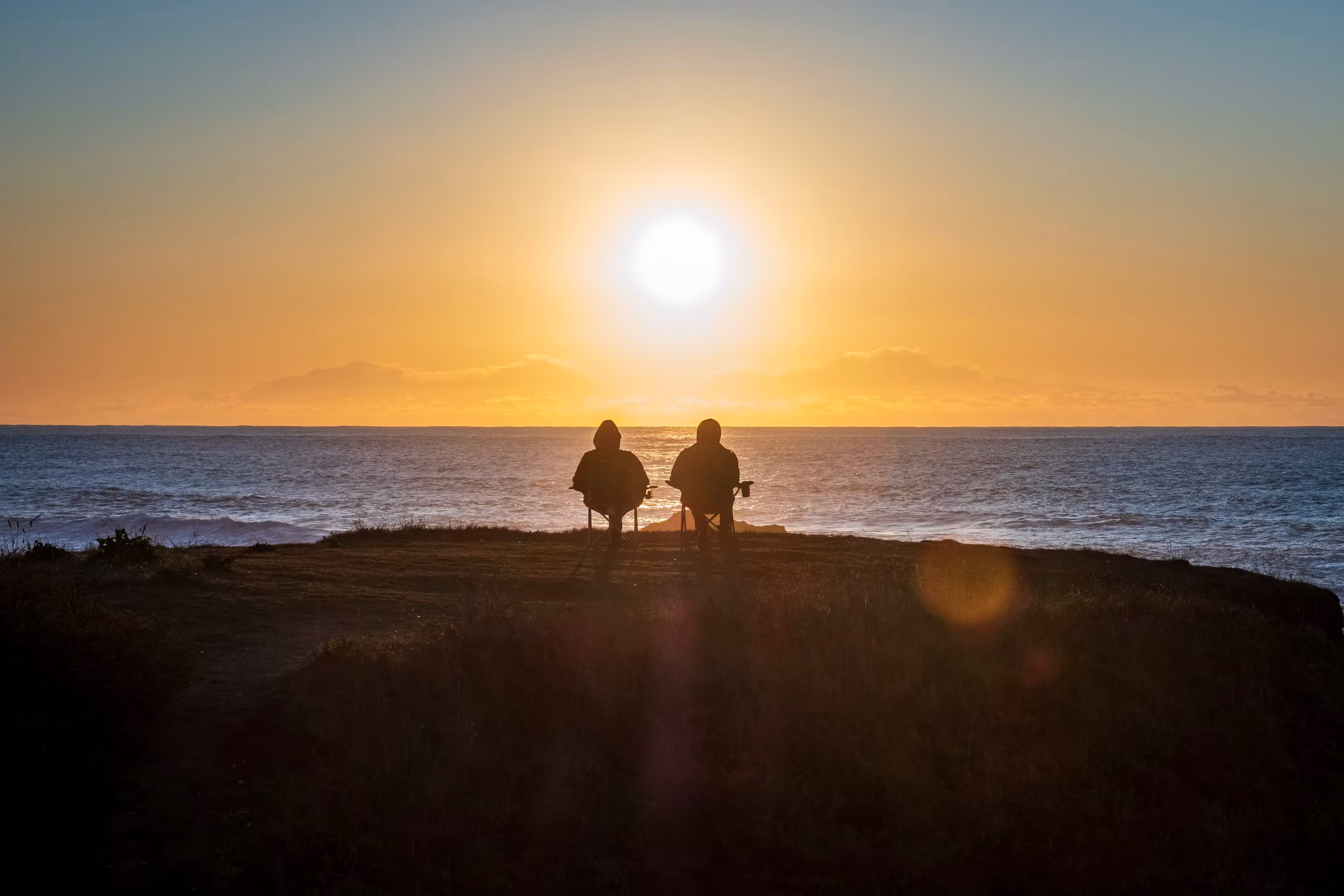 couple overlooking the sunset as they relax